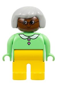 Duplo Female - Female Duplo figure with yellow legs, light green top with heart buttons, gray hair, and brown head - 4555pb012