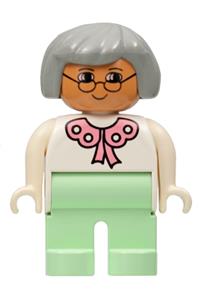 Duplo Female - Female Duplo figure with light green legs, wearing a white blouse, gray hair, and glasses - 4555pb014