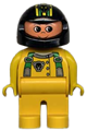 Male Duplo figure with yellow legs, wearing a yellow top with green racer suspenders and a black helmet with stripes and bear pattern - 4555pb083