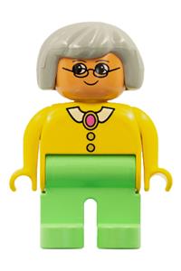 Duplo Female - Female Duplo figure with medium green legs, wearing a yellow blouse with collar, gray hair, and glasses - 4555pb084