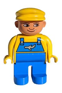 Duplo Male - Male Duplo figure with blue legs, wearing a yellow top with blue overalls featuring an airplane design, and a yellow cap - 4555pb105