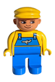 Male Duplo figure with blue legs, wearing a yellow top with blue overalls featuring an airplane design, and a yellow cap - 4555pb105