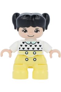 Duplo Child Girl - Lego Ville Duplo figure, young girl with bright light yellow legs, white top with black hearts, black hair in pigtails, light nougat skin - 47205pb079