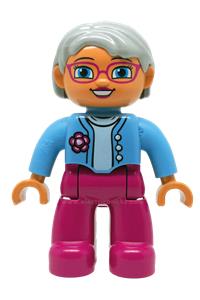 Duplo Female - Female Duplo figure from Lego Ville with magenta legs, medium blue top featuring a flower, light bluish gray hair, blue eyes, and glasses - 47394pb173