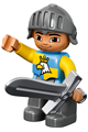 Duplo Ville male castle figure with dark bluish gray legs, blue/yellow chest with crowned eagle, wearing a helmet - 47394pb178