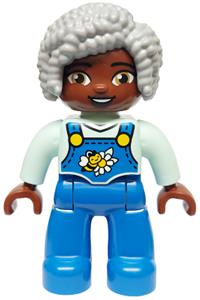 Duplo Female - Female Duplo figure from Lego Ville with blue legs, wearing overalls and accessorized with a bee and daisy, light bluish gray hair - 47394pb357
