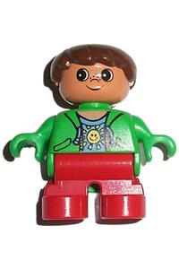 Duplo Child Boy - Child Duplo figure with red legs, wearing a green top with a sun pattern shirt, and brown hair - 6453pb008