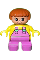 Duplo child girl with dark pink legs, wearing a yellow top with dark pink overalls and heart details - 6453pb022
