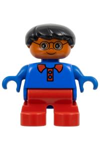 Duplo Child Boy - Boy Duplo figure with red legs, black hair, glasses, wearing a blue top with red collar - 6453pb044