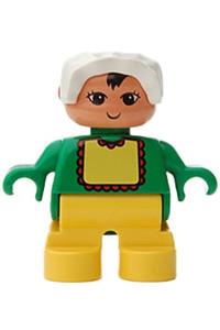 Duplo Baby - Baby Duplo figure with yellow legs, wearing a light green top with white bib and dark pink lace, topped with a white bonnet - 6453pb052