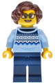 Female antique shop worker with reddish brown wavy hair wearing a bright light blue knit Fair Isle sweater and dark blue legs - bdp228