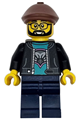 Male race truck driver with a black jacket over a dark turquoise shirt with a hawk head logo, dark blue legs, reddish brown flat cap, beard, and glasses - cty1743