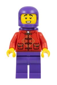 Lunar New Year Parade Participant - Male participant in Lunar New Year parade wearing a red tang shirt, dark purple legs, space helmet, and air tanks - hol319