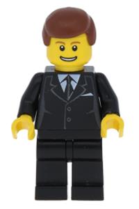 Male in Black Suit Minifigure - Male minifigure in a black suit with reddish brown hair and a thin grin with teeth - trn142
